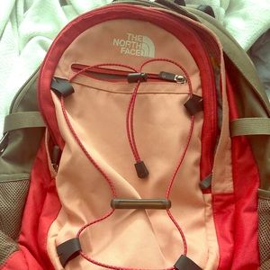 Pink and red north face backpack